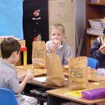 Image of children eating food in a classroom