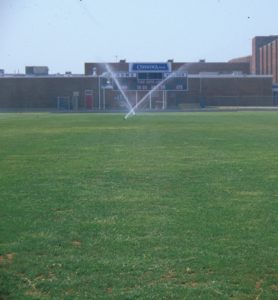 Sprinklers watering a sports field