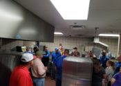 people standing in school kitchen