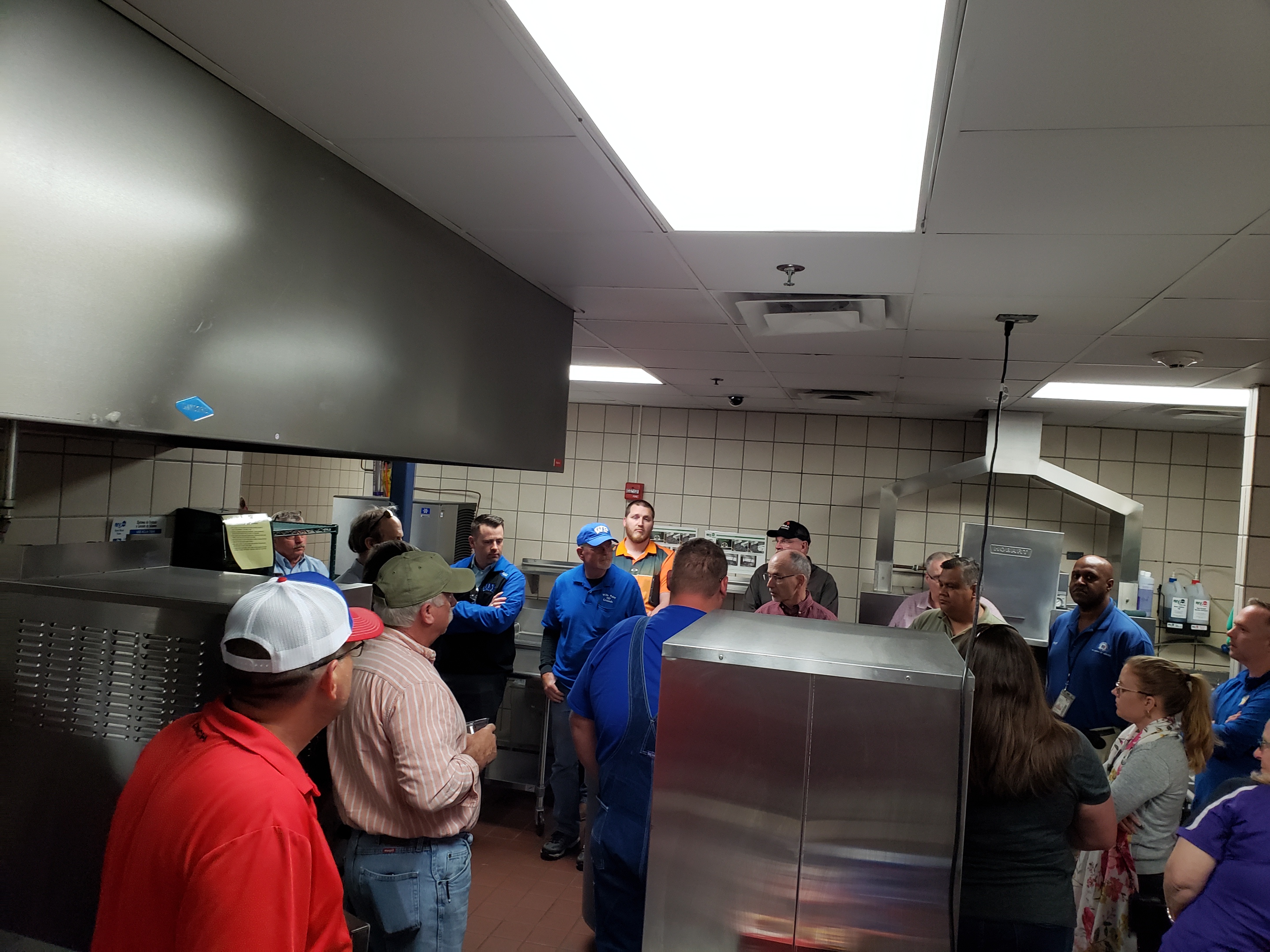 people standing in school kitchen